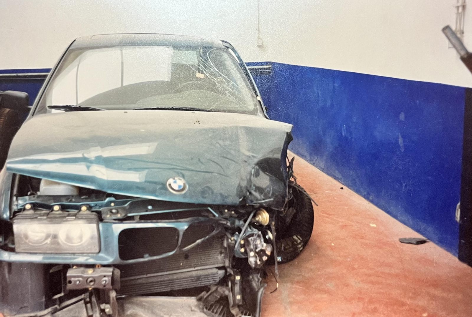 Het front van dezelfde BMW vóór de herstelling, met zware schade
